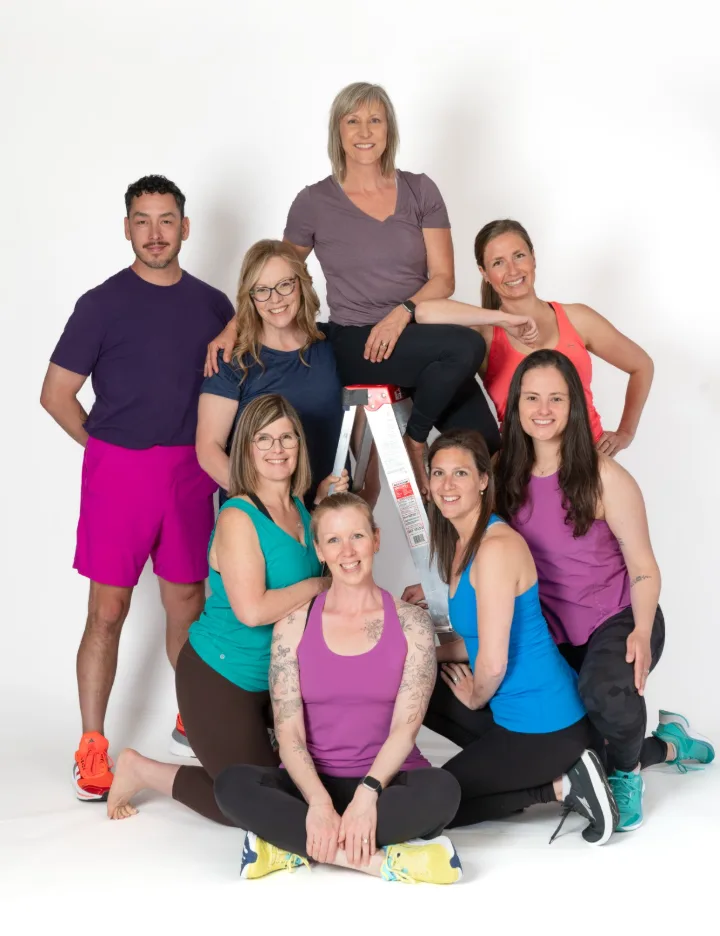 The Studio IPF instructor team posing together around a ladder